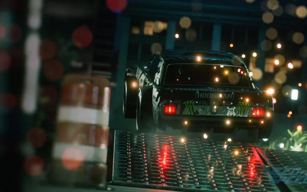 A dynamic HD desktop wallpaper from Need For Speed (2015) features a sleek car racing through a vibrant, illuminated urban environment with reflective surfaces and action-packed energy.
