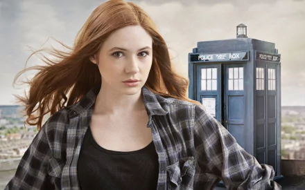 HD desktop wallpaper featuring Karen Gillan as Amy Pond from the TV show Doctor Who (2005) with the TARDIS in the background.