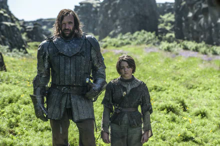 Arya Stark, portrayed by Maisie Williams, stands beside Sandor Clegane, played by Rory McCann, in a scene from Game of Thrones, set against a lush, green backdrop.