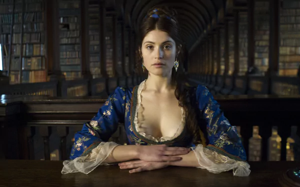 Gemma Arterton in a detailed blue period costume from the movie Byzantium, set against a richly lit, grand library interior, 4K Ultra HD desktop wallpaper.