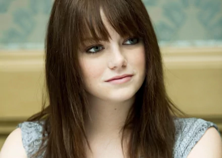 Emma Stone smiles softly in this 4K Ultra HD wallpaper, capturing her natural beauty and charm in a serene setting. A striking background enhances her captivating presence.