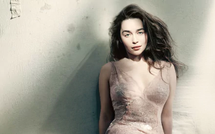 A captivating HD desktop wallpaper featuring celebrity Emilia Clarke, showcasing her striking presence and elegance against a soft, muted background.
