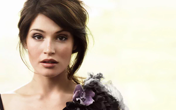 A close-up of brunette actress Gemma Arterton, showcasing her striking features and elegant style against a soft, light background. This HD image serves as a stylish desktop wallpaper.