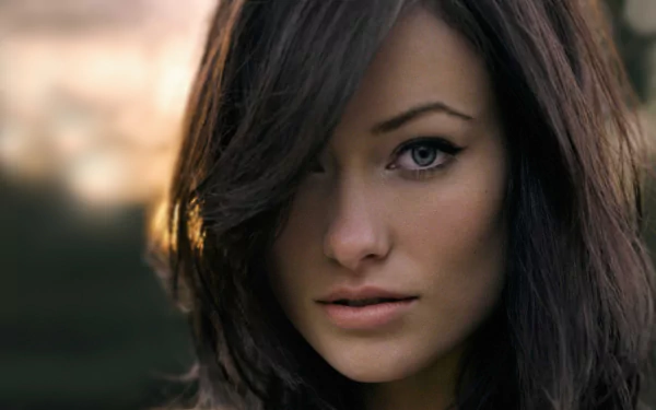 HD PC desktop wallpaper featuring a close-up portrait of celebrity Olivia Wilde with a soft-focused background.