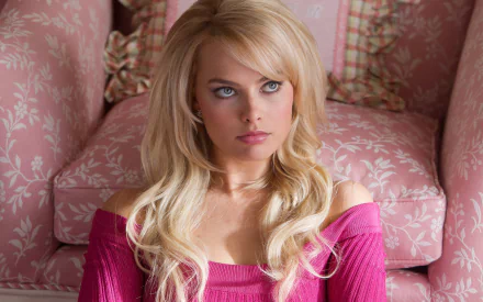 Margot Robbie as Naomi Lapaglia in a scene from *The Wolf of Wall Street*, featuring her captivating look against a soft pink background. HD wallpaper and background.
