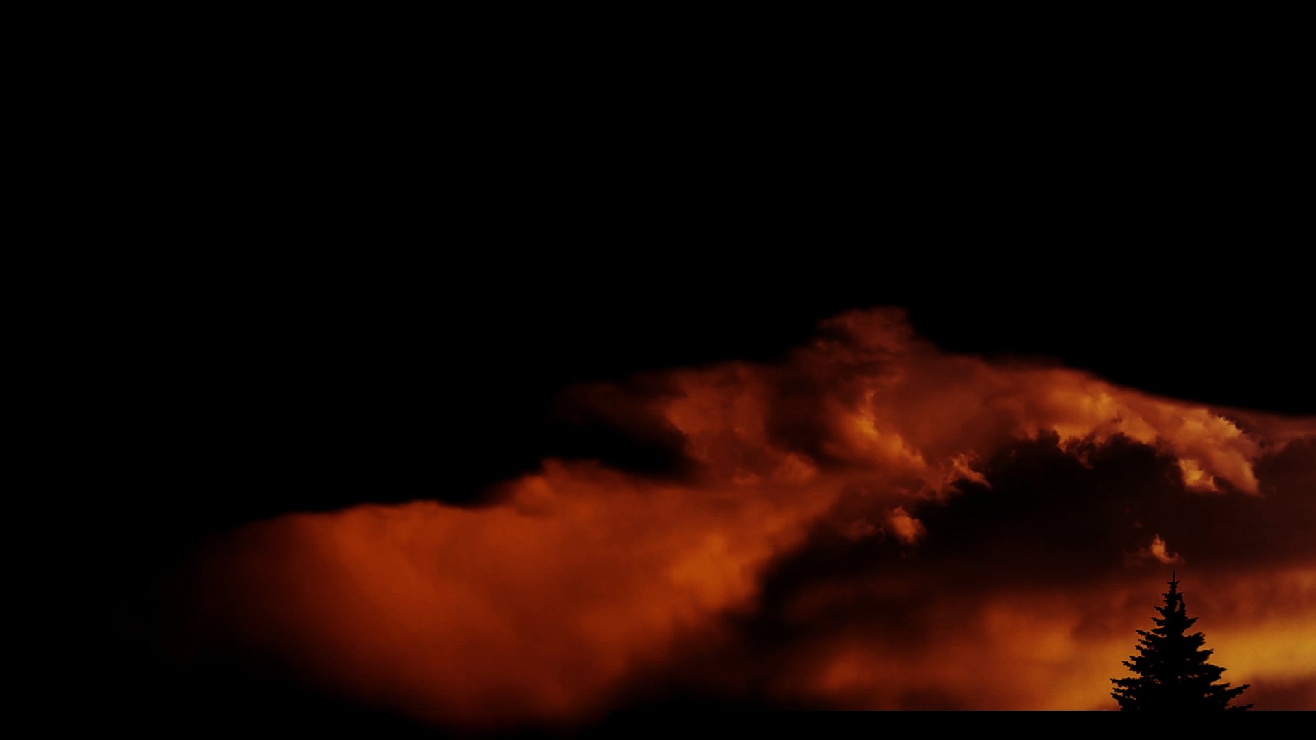 HD desktop wallpaper featuring a dark sky illuminated by fiery clouds above a silhouetted tree, blending elements of fire, cloud, and nature photography.
