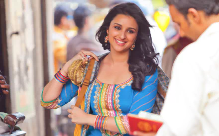 An HD wallpaper featuring Parineeti Chopra in a vibrant blue outfit, capturing a moment from the movie *Shuddh Desi Romance*, radiating warmth and charm.