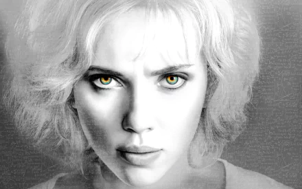 Close-up black-and-white HD wallpaper of Scarlett Johansson as Lucy, featuring intense yellow eyes and a focused expression.