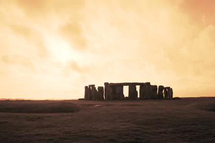 A captivating HD wallpaper depicting Stonehenge at sunset, showcasing the ancient stone structure against a dramatic sky, highlighting its man-made grandeur.