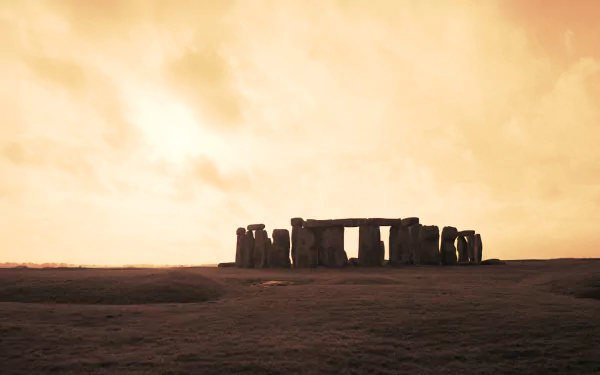 A captivating HD wallpaper depicting Stonehenge at sunset, showcasing the ancient stone structure against a dramatic sky, highlighting its man-made grandeur.