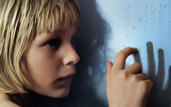 HD PC desktop wallpaper: close-up of a pale blond child pressing a hand to a fogged window, shadow cast on blue glass — moody scene from the movie Let the Right One In.
