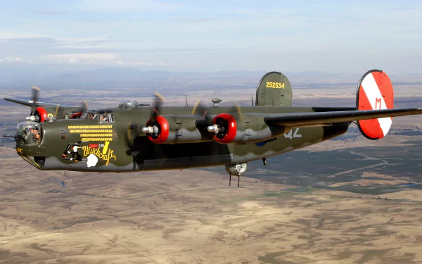 HD desktop wallpaper showcasing a military Consolidated B-24 Liberator bomber flying over a desert landscape.