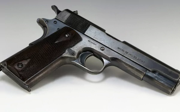 A detailed HD wallpaper featuring a Colt 1911 handgun, showcasing its classic design and craftsmanship against a subtle background.