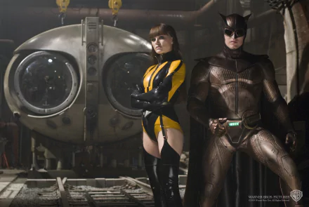 HD PC desktop wallpaper featuring characters from the movie Watchmen, showcasing Silk Spectre and Nite Owl in their iconic costumes inside an industrial setting.