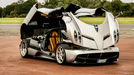A stunning Pagani Huayra showcases its unique design with butterfly doors open, gleaming in high-definition. This image makes a striking desktop wallpaper and background.