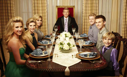 HD PC desktop wallpaper background of a TV show cast: a dressed family gathered around a formal dining table, father at the head, floral centerpiece and elegant curtains.