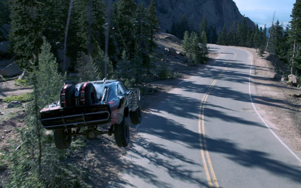 A high-definition desktop wallpaper from Furious 7, featuring a car soaring over a winding mountain road surrounded by lush trees and rugged terrain.