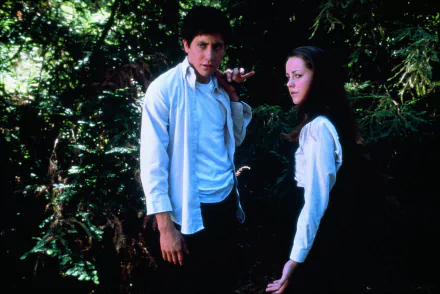 Jake Gyllenhaal and Jena Malone in a scene from the movie Donnie Darko, set in a forest. This HD desktop wallpaper showcases a moment from the film.