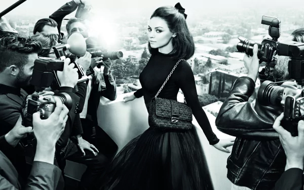 Black-and-white 4K Ultra HD desktop wallpaper featuring celebrity Mila Kunis posing elegantly amid photographers.