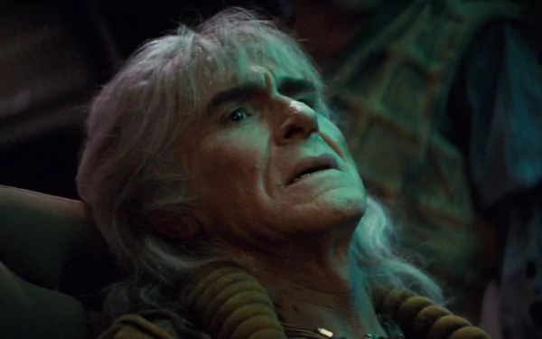 HD desktop wallpaper: close-up of an aging man with long white hair reclining, green-tinted dramatic lighting in a tense moment from Star Trek II: The Wrath of Khan.