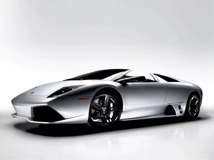 A sleek Lamborghini Murcielago showcases its stunning design in this HD desktop wallpaper, featuring sharp lines and a striking silver finish against a minimalist background.