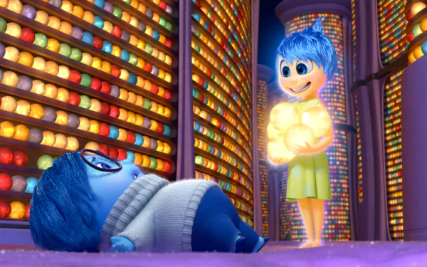 HD PC desktop wallpaper from the movie Inside Out: Joy holding glowing memory orbs beside Sadness in a colorful memory storage room.