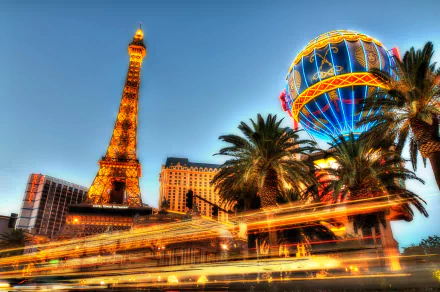4K Ultra HD image of the Paris Las Vegas hotel and casino, showcasing its illuminated Eiffel Tower replica and vibrant hot air balloon sign against a twilight sky.