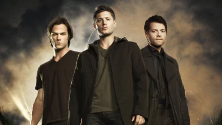 Three main characters from the TV show Supernatural stand confidently against a dramatic background, showcasing the essence of the series in this HD desktop wallpaper.