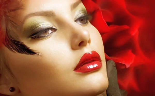 Close-up of a woman with bold makeup, red lips, and a red rose background, featuring Judy Wilkins in an HD PC desktop wallpaper.