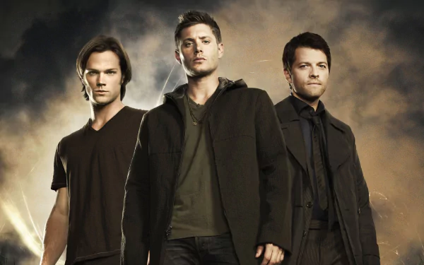 Three main characters from the TV show Supernatural stand confidently against a dramatic background, showcasing the essence of the series in this HD desktop wallpaper.