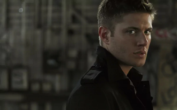 A striking HD wallpaper featuring a character from the TV show Supernatural, showcasing a contemplative expression against an industrial backdrop.