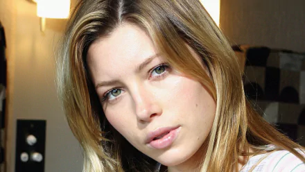 A stunning HD PC desktop wallpaper featuring celebrity Jessica Biel with her signature long hair and expressive gaze, set against a softly lit background.