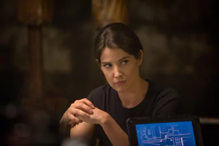 Maria Hill, portrayed by Cobie Smulders, is captured in a thoughtful moment from Captain America: The Winter Soldier, set against a backdrop of intrigue and action.