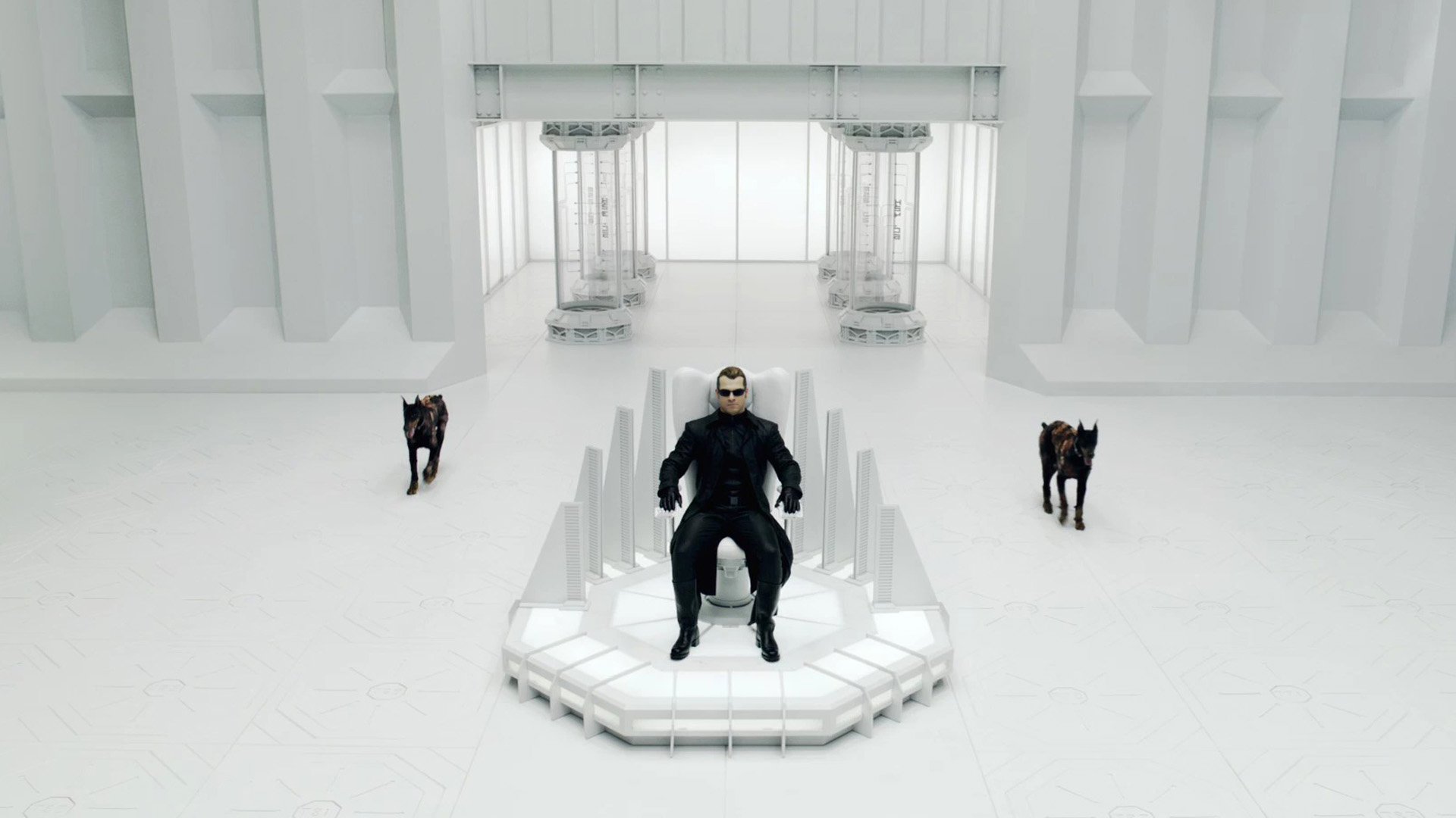 HD PC desktop wallpaper featuring a scene from the movie Resident Evil: Afterlife, showcasing a central figure seated with two dogs in a stark, futuristic white setting.