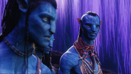 A vivid HD wallpaper featuring characters from the movie Avatar, showcasing the unique blue-skinned Na'vi in a mystical setting with purple foliage in the background.