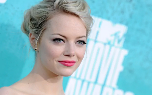 HD PC desktop wallpaper featuring a close-up portrait of celebrity Emma Stone with a soft blue background.