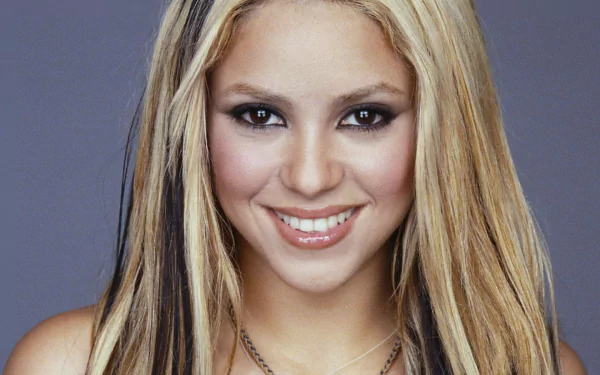 HD PC desktop wallpaper featuring a close-up portrait of Shakira with her signature blonde hair, representing music and pop culture.
