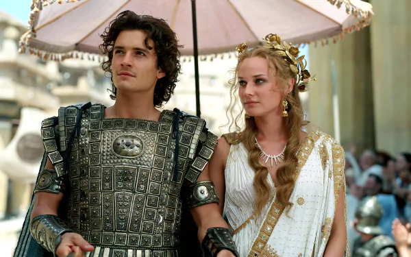 HD desktop wallpaper featuring Orlando Bloom and Diane Kruger in their roles from the movie Troy, dressed in ancient Greek attire.