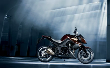 HD PC desktop wallpaper: Kawasaki Z1000 motorcycle in a dim industrial hangar, dramatic beams of light highlighting its sleek black-and-red body.