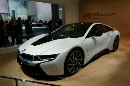 A sleek BMW i8 displayed in a modern setting, showcasing its futuristic design. This 4K Ultra HD image serves as an impressive PC desktop wallpaper and background.