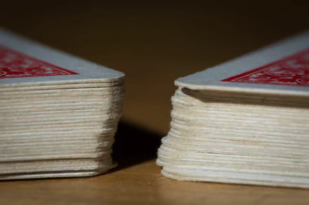 Close-up of two decks of playing cards, showcasing the texture and details of the edges. This high-definition image serves as a striking desktop wallpaper and background.