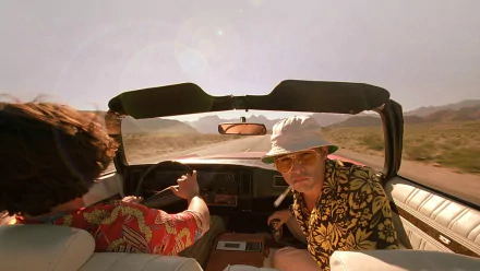 HD desktop wallpaper featuring Johnny Depp in the movie Fear and Loathing in Las Vegas, driving through a desert landscape in a convertible.