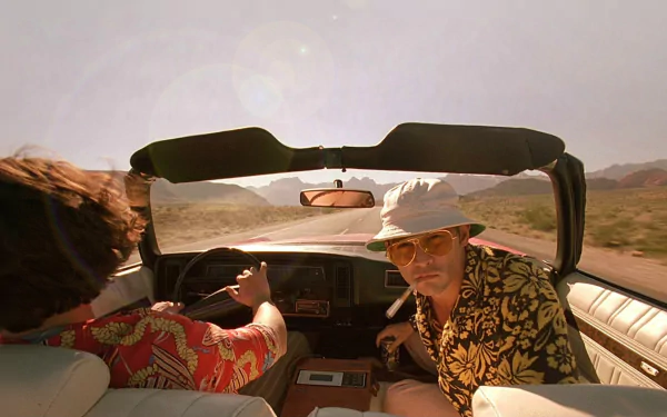 HD desktop wallpaper featuring Johnny Depp in the movie Fear and Loathing in Las Vegas, driving through a desert landscape in a convertible.