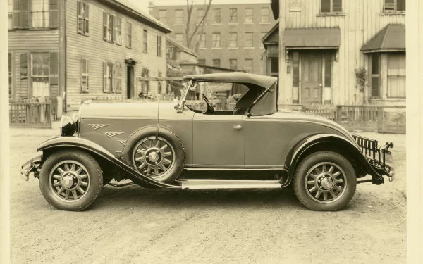 Sepia side view of a vintage Chrysler coupe parked on an early 20th-century street — 2K Quad HD PC desktop wallpaper and background.