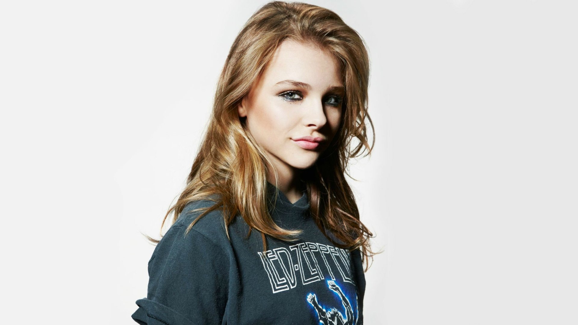 Chloë Grace Moretz poses confidently in a stylish hoodie, creating a striking HD wallpaper and background that captures her youthful charm and charisma.