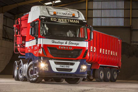 A striking 4K Ultra HD image of an Iveco truck, prominently displaying the ED WEETMAN branding, set against a warehouse backdrop, showcasing its rugged design and vibrant colors.