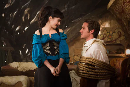 A scene from the movie Mirror Mirror featuring Lily Collins and Armie Hammer, showcasing a playful moment between the characters in a whimsical setting.