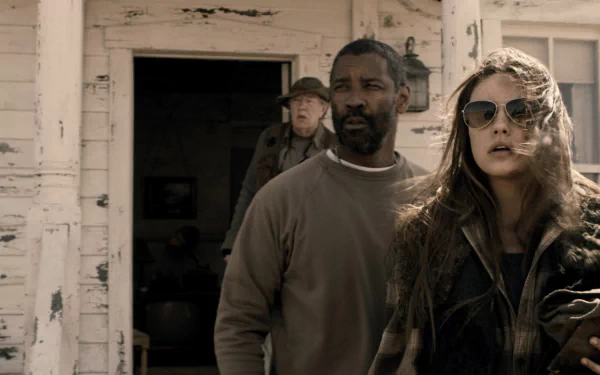 HD PC wallpaper featuring two actors from the movie The Book of Eli: a rugged man and a woman in sunglasses at a weathered porch in a post‑apocalyptic setting.