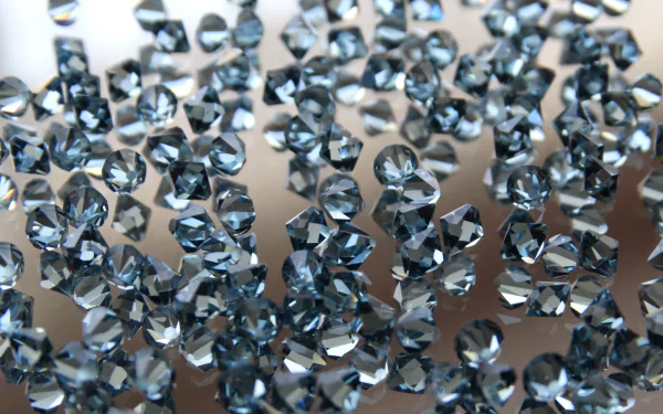 A dazzling HD desktop wallpaper featuring a collection of sparkling blue gemstones, including diamonds and topaz, set against a neutral background.