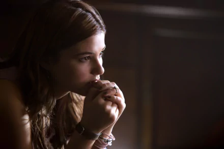 A contemplative Stefanie Scott in a scene from Insidious: Chapter 3, captured beautifully in a 4K Ultra HD desktop wallpaper and background.